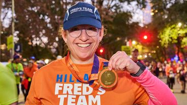 Hillary Gardenswartz holds up her finisher medal at the TCS New York City Marathon. 